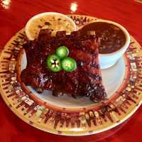 <p>Apple brine jalapeño smoked ribs with an apple bbq sauce at Taino Smokehouse in Spring Valley.</p>