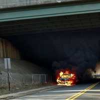 <p>Flames consume car Thursday under Route 80 at Ridgefield Park/Bogota border.</p>