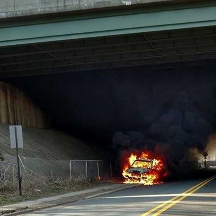 Flames consume car Thursday under Route 80 at Ridgefield Park/Bogota border.