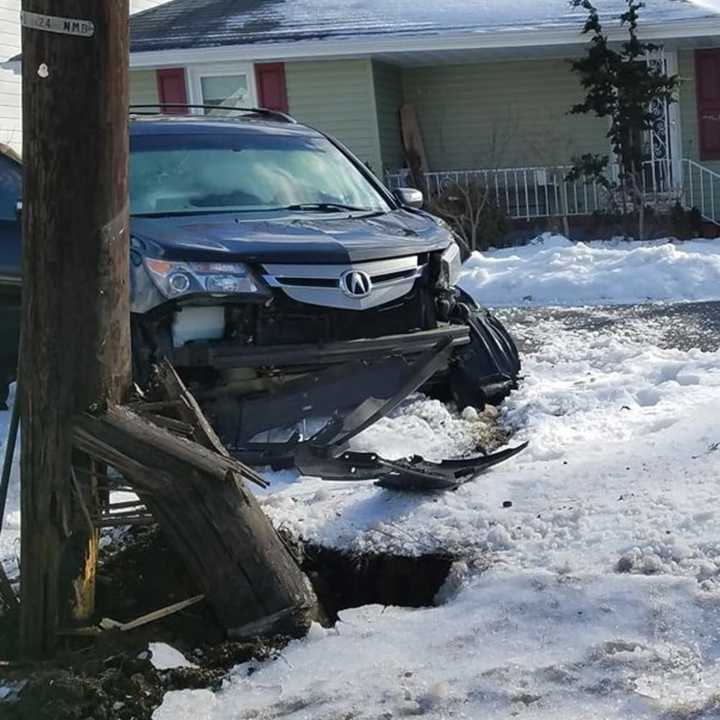 The pole, held by wires, swayed slightly over the roadway.