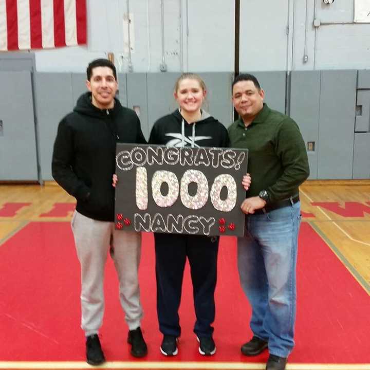 Ruf and her travel coaches after hitting her 1,000th point.