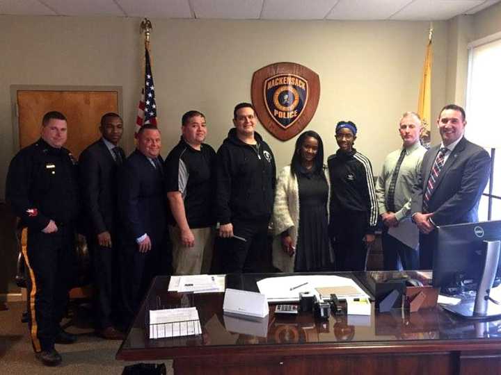 FROM LEFT: Officer Frank McCall, Detective James Travon, Detective James Luther, Detective John Mora, Officer Frank Cavallo, Andrea Kelly, D&#x27;monique Kelly, Capt. Patrick Coffey, Detective Mark DelCarpio