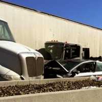 <p>The tractor-trailer was removed but two vehicles remained at the scene awaiting tow trucks as of 4 p.m., police said.</p>