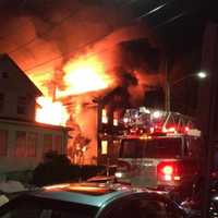 <p>Firefighters battled a two-alarm blaze that destroyed a Mount Vernon home and spread to other buildings overnight.</p>