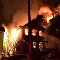 <p>Firefighters battled a two-alarm blaze that destroyed a Mount Vernon home and spread to other buildings overnight.</p>