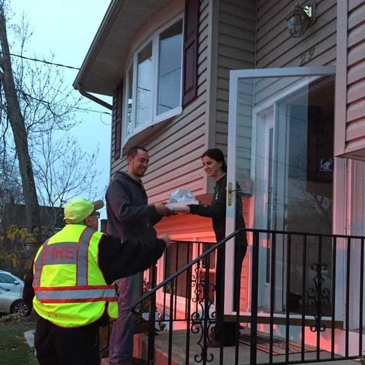 Congers firefighters deliver food from a local restaurant to teach about fire safety.