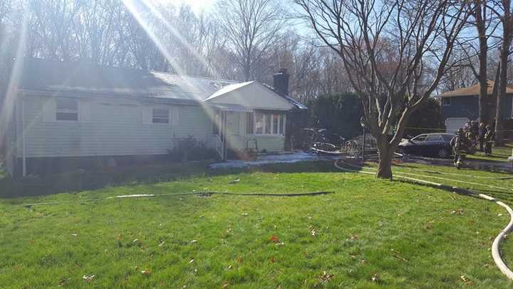 The Shelton Volunteer Fire Co. assists the Stratford Fire Department at a house fire on North Peters Lane on Tuesday morning.