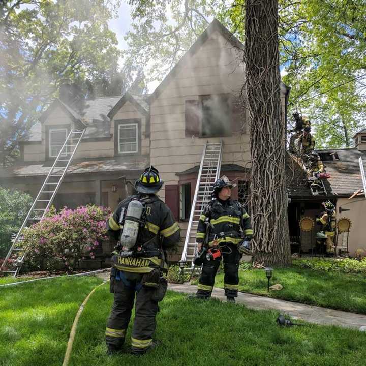 Hackensack firefighters work a Teaneck blaze Monday.