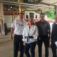 <p>Devon Walsh with some of the responders who helped pull her from her vehicle.</p>