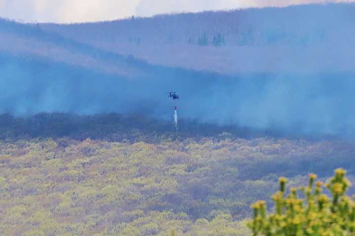 A helicopter was used to douse the brush fire in Western Massachusetts.