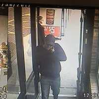 <p>This is the suspect in an armed robbery at the People&#x27;s Bank inside Stop &amp; Shop at 898 Bridgeport Ave. in Shelton. The photo was captured by surveillance cameras as he entered the store.</p>