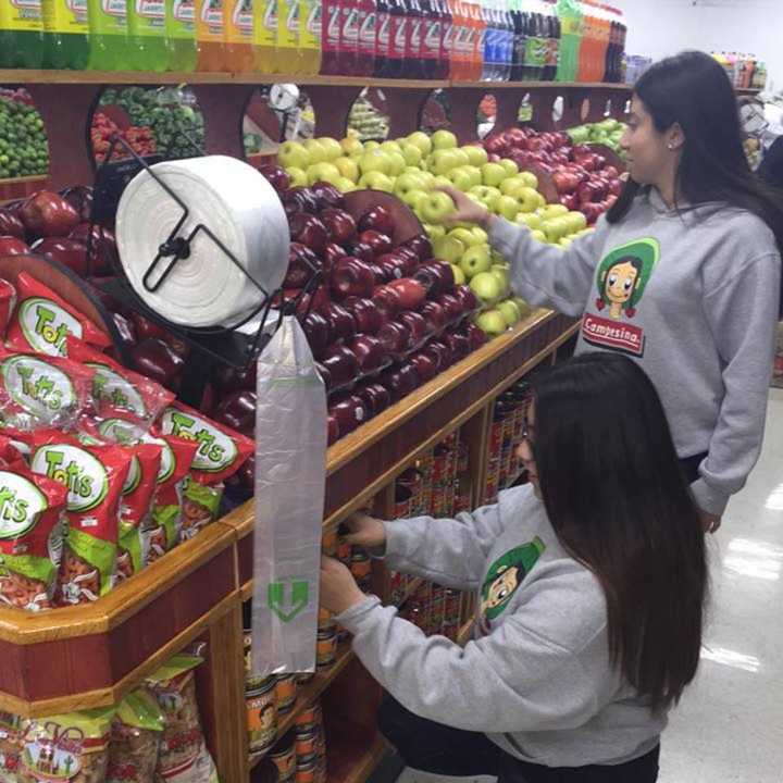 Employees organize the shelves at Campesina Farm in Garfield.