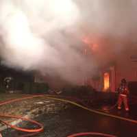 <p>Firefighters from multiple departments assisted in fighting the fire on Shadow Lane in Wilton on Thursday.</p>