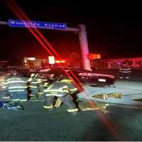 <p>Bridgeport firefighters work to remove an injured police officer from the vehicle.</p>