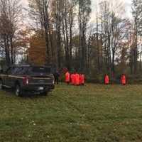 <p>DEC rangers and state police prepare to retrieve the body of a missing hiker.</p>