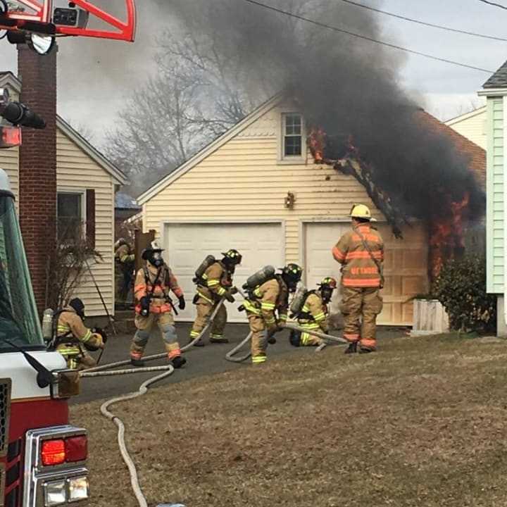 A detached garage caught fire after hot ashes were placed in a plastic recycling bin.