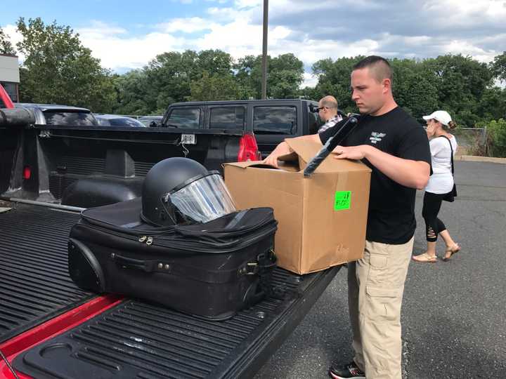 An officer prepares to return his equipment in Hackensack.