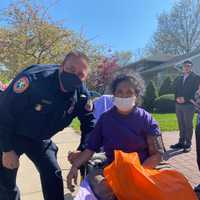 <p>Nassau County Police Officer Robert Simon came to the rescue of a 57-year-old woman when a fire broke out in Searington.</p>