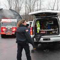 <p>CPD Officer Macon keeps a watchful eye on the firefighters working the scene in Mahopac.</p>