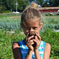 <p>One of HealthBarn USA&#x27;s young farmers shows off a home-grown potato.</p>