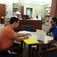 <p>Lazaro Conde (left) and Stephen Lacatena studying at the Ridgefield Public Library. </p>