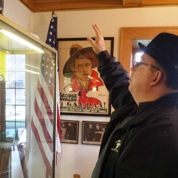 Tom Meyers, director of the Fort Lee Film Commission, addresses one of the display cases. 