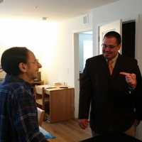 <p>Tom Kania shows off his new home to Tedesco and AJ Bauer, director of veterans affairs.</p>