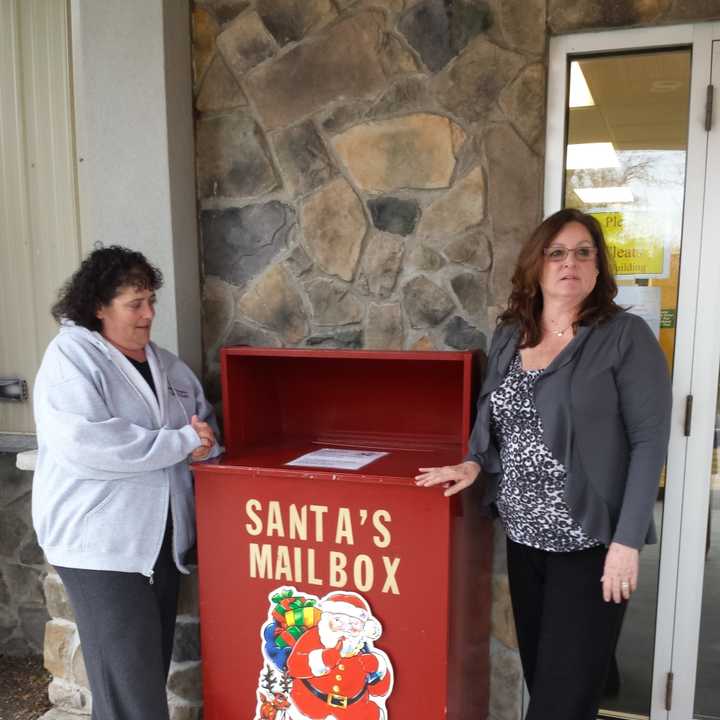 Gina Giardini and Cresskill Recreation Director Barbara Mann help collect letters to Santa. 