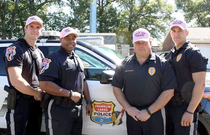 Standing Left to right: Officer Donald Wilson, Officer Brandon McNEIL, Chief Carmine Pezzuti and Sgt. Mark McCombs