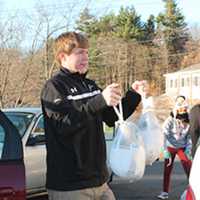 <p>Upon arrival, the Wooster students helped distribute the bags of donated food.</p>