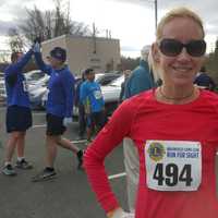 <p>Sara Belles of Brookfield posts the fastest time among female runners in the New Year’s Day Brookfield Lions Run for Sight 4-mile race on Friday.</p>