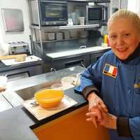 <p>Méli-Mélo Catering Manager, Chef Nadia Ramsey poses next to a bowl of soup.</p>