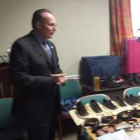 <p>Harrison Police Chief Anthony Marraccini shows stolen goods and fake ID recovered this week after arresting three suspects in a car break-in Sunday in Purchase. In addition to cash and cellphones, police recovered luxury handbags, belts and shoes.</p>