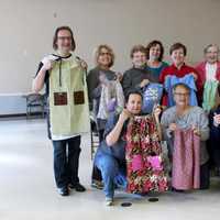 <p>Liz Skarzynski (kneeling, left) organizes and hosts sewathons for Dress A Girl Around The World.</p>