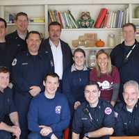 <p>The Ridgewood Fire Department with HealthBarn USA founder Stacey Antine.</p>