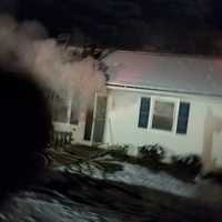 <p>A fire rips through this home at 44 Fleetwood Drive in Danbury early Sunday.</p>