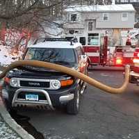 <p>Danbury firefighters battling a blaze at a home at 44 Fleetwood Drive in Danbury early Sunday had to work around a car parked in front of the closest hydrant.</p>