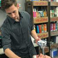 <p>Iconic Barbershop owner Casey Terramoccia and Ridgewood Officer Jack Knudsen</p>