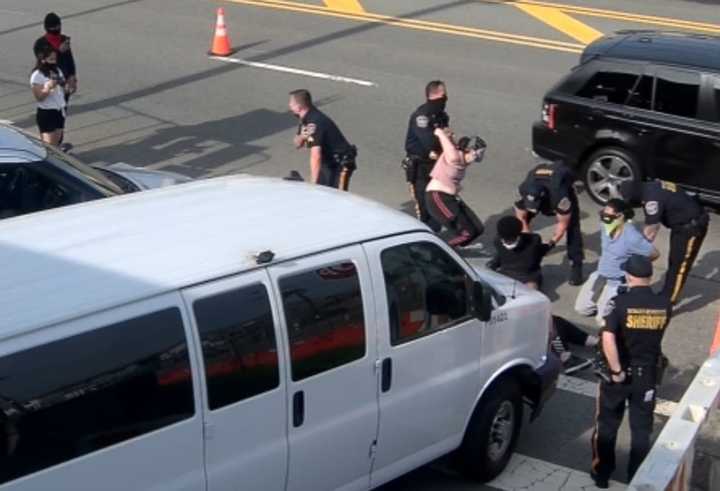 Protestors being taken into custody outside Bergen County Jail.