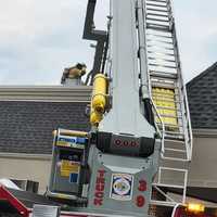 <p>A firefighter on the roof of Village Square Plaza.</p>