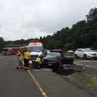 <p>Nichols Fire Department crews respond to a two-car crash on the northbound Merritt in Trumbull on Saturday.</p>