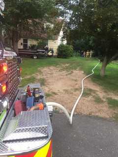 Trumbull Fire Crews Battle Burning Brush, Debris Behind Home