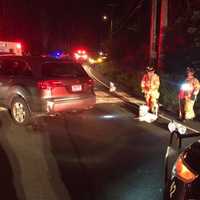 <p>Weston volunteer firefighters work at the scene of a two-vehicle crash late Saturday.</p>