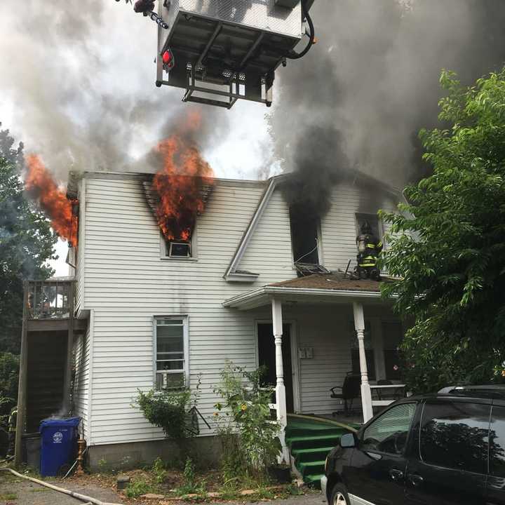 Smoke and fire pour from a home at 67 Fair St. as the Norwalk Fire Department goes to work to extinguish the blaze Saturday.