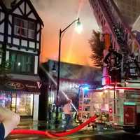 <p>Firefighters douse an alleyway to keep blaze from spreading to F&amp;D Frame Shop.</p>