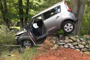 SUV Lands Atop Stone Wall After Crash In Shelton