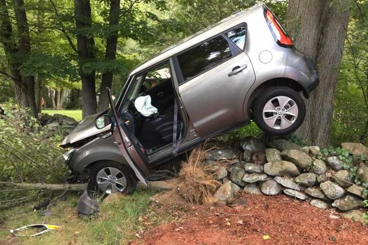 SUV Lands Atop Stone Wall After Crash In Shelton