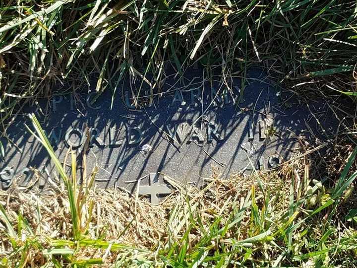 One of the overgrown stones at the Paramus cemetery.