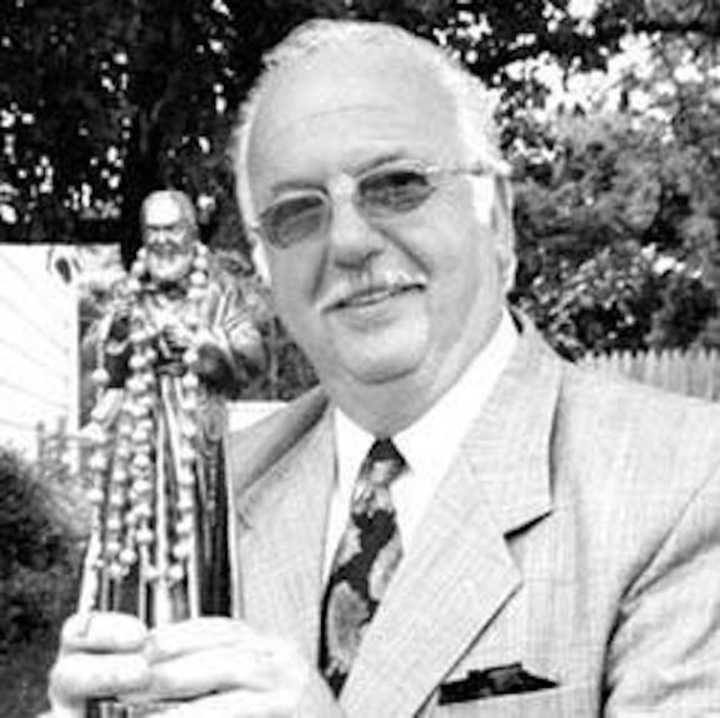 Anthony Fuina holding a statue of Padre Pio