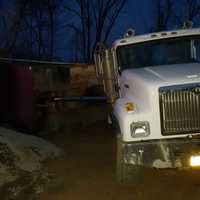 <p>The bed of a dump truck overturned while workers were unloading cargo in New Hempstead.</p>